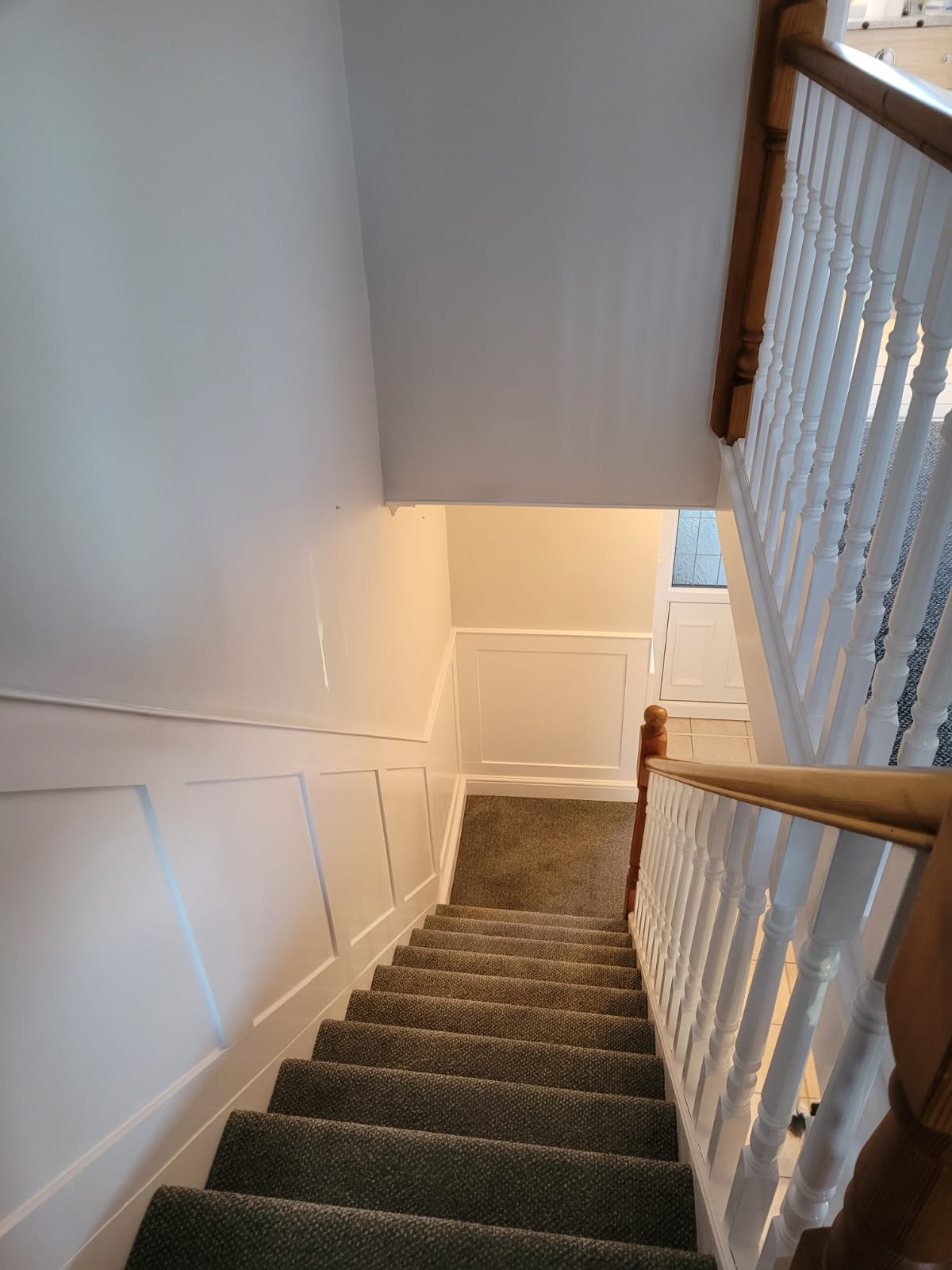Freshly painted staircase with wall panelling and new carpet in a Wakefield home